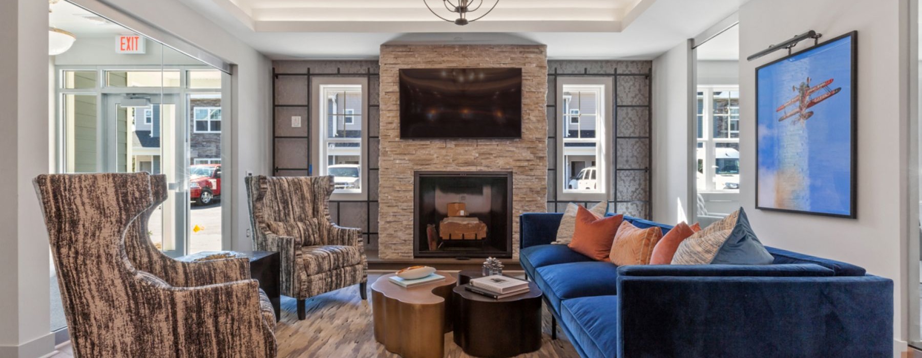 a lounge with seating windows and a tv