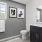 Well lit bathroom with standup shower and hardwood flooring