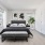 Spacious Bedroom with Large Windows and Hardwood Flooring