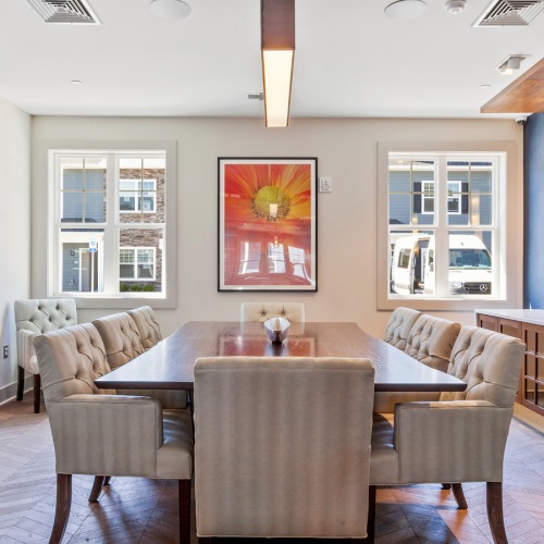 Conference Room naturally lit clubhouse conference space with large table surrounded by chairs
