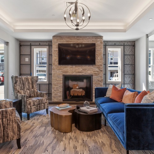 Clubhouse brightly lit fireplace and seating area in clubhouse